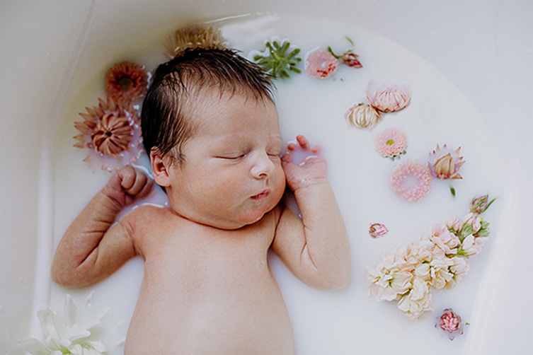 diy newborn photography taking a milk bath