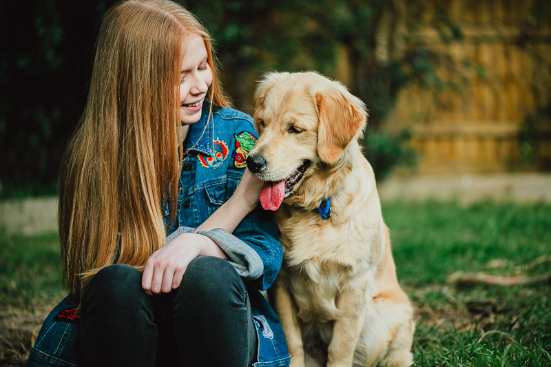 red haired girl with golden retriever
