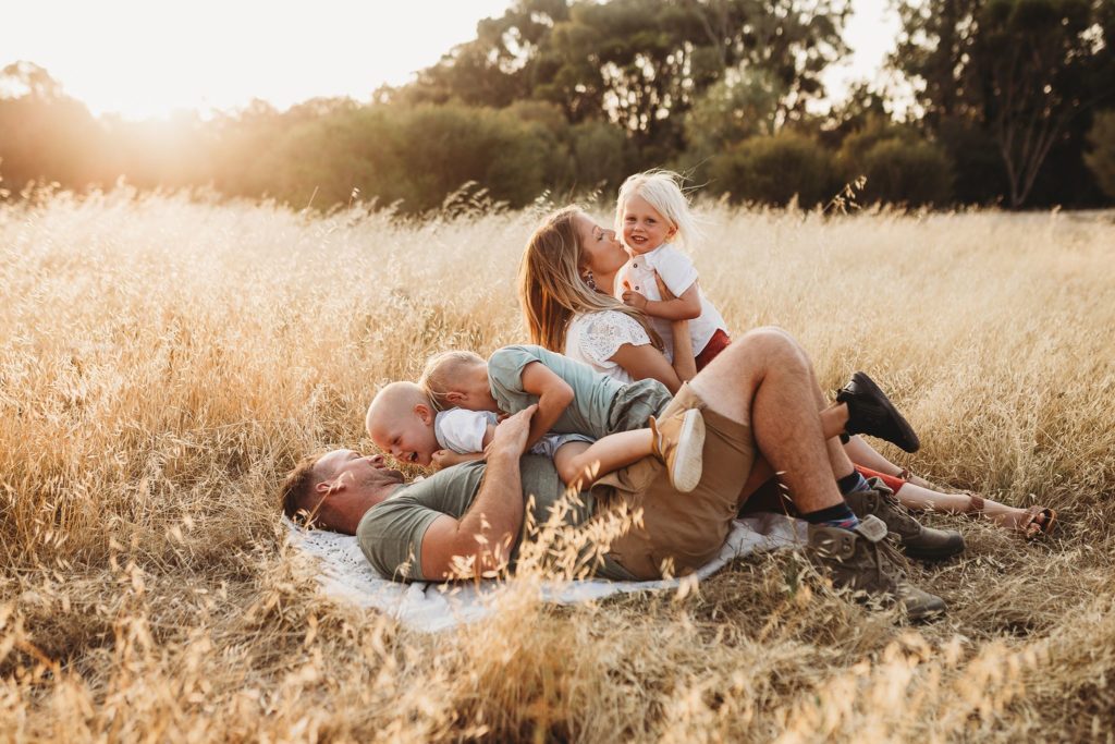 lifestyle shot of parents with children playing together