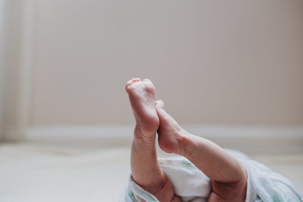 baby feet in faceless portrait