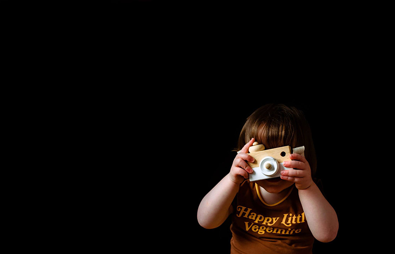 cool photoshoot ideas at home with little boy holding toy camera