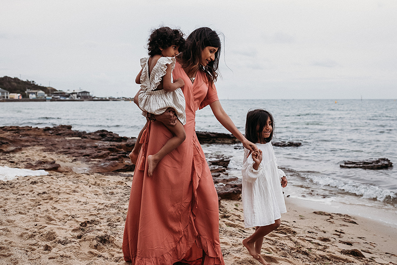 motherhood session of woman by the sea with her children