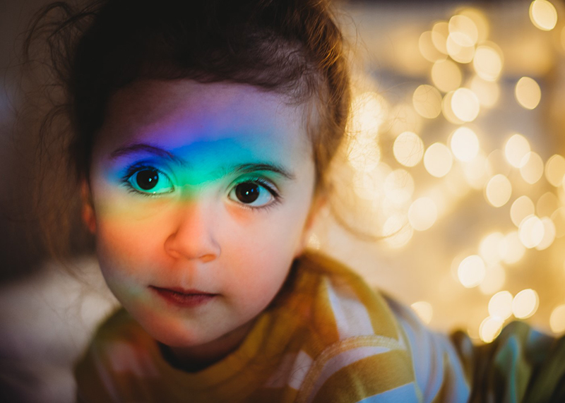 rainbow colours over little girl’s face