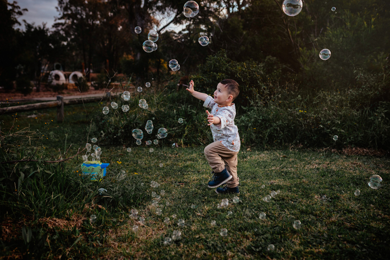 bubble pictures of toddler boy chasing bubbles
