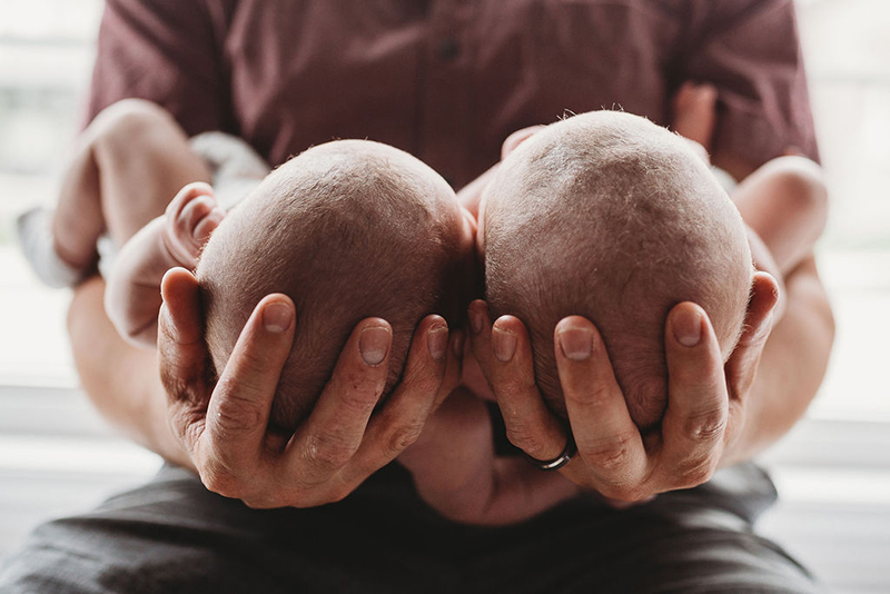  man holding newborn twins