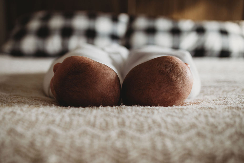 newborn twins on bed photo from overhead