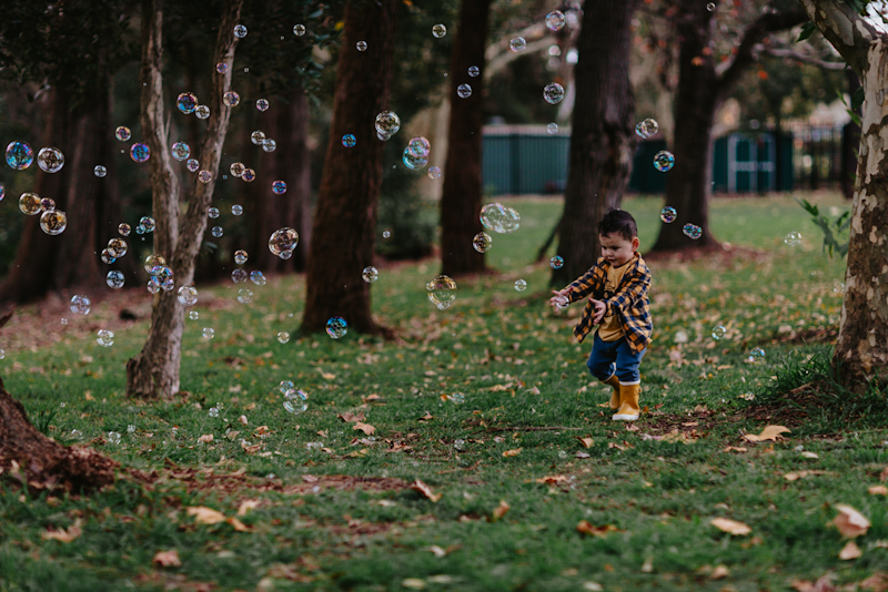 little toddler having fun with bubble photography
