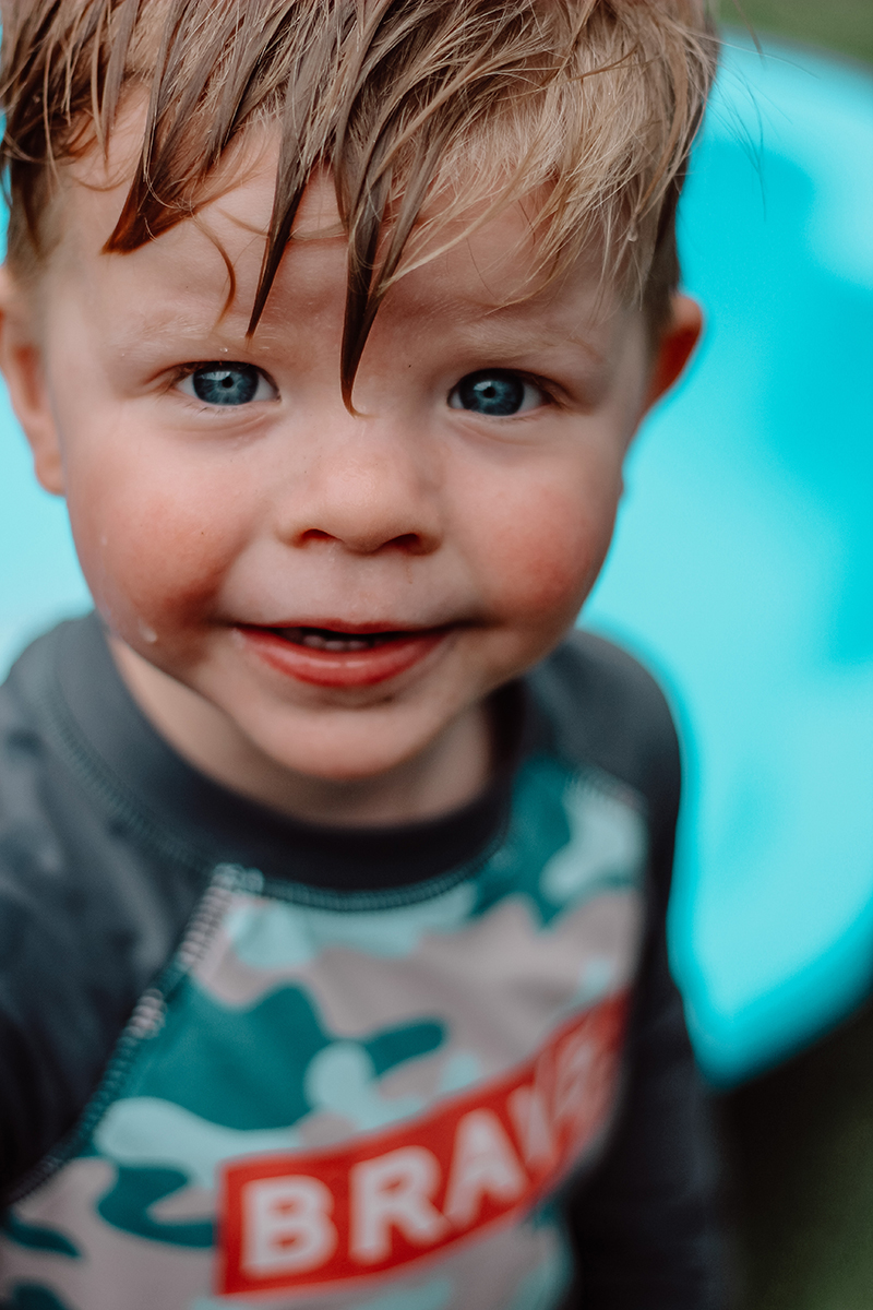 toddler boy with wet hair wearing a swimming vest photography courses