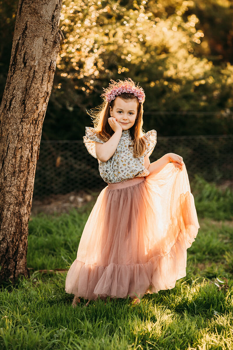 backlit portrait of girl dressed in pink