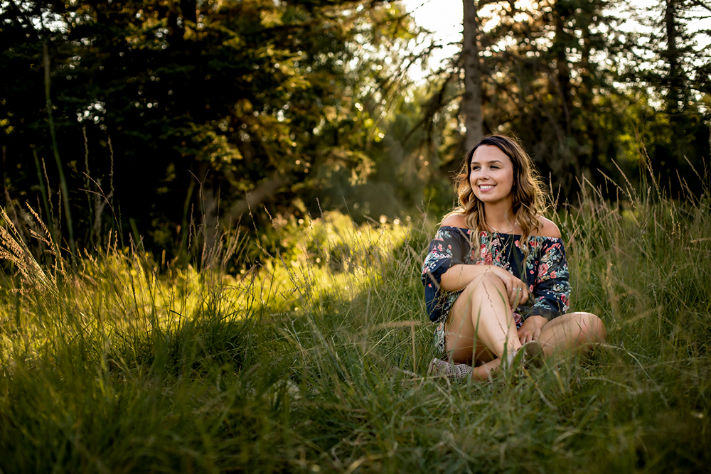 teenage girl posing in a field