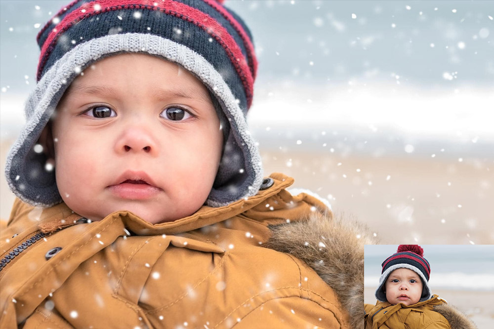 toddler boy wearing beanie on beach with snow
