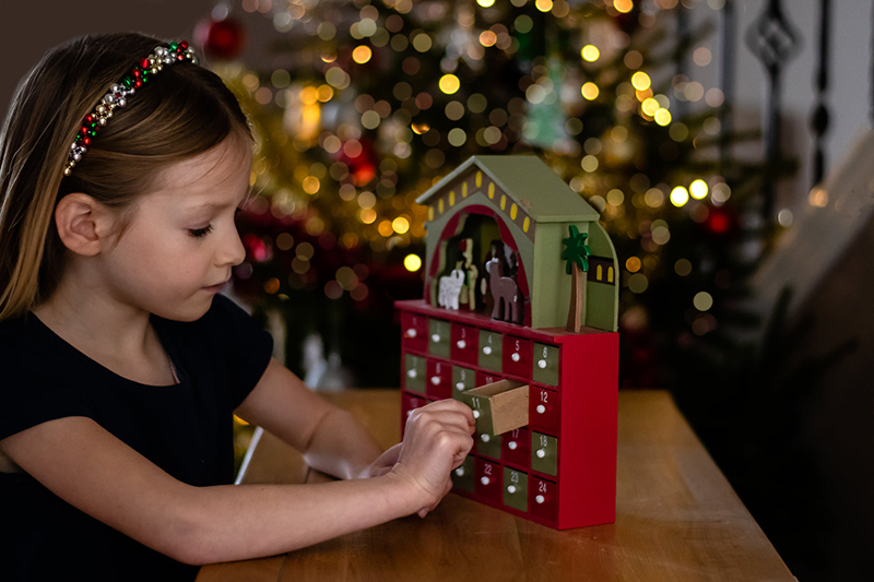 girl playing with a advent calendar