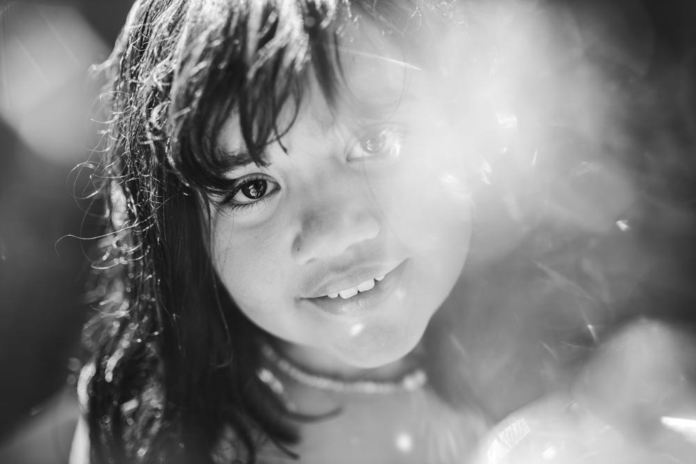 black and white portrait of young girl with bokeh