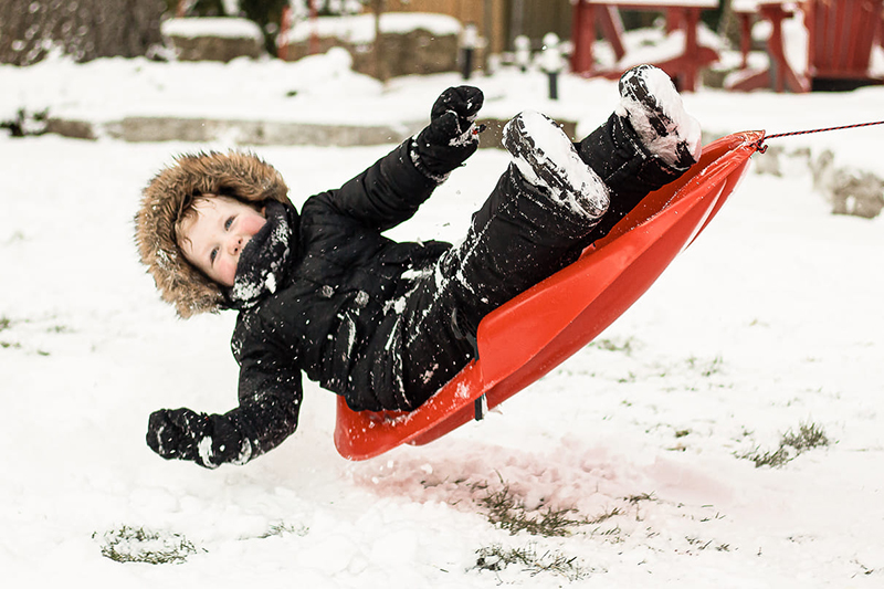 snow photography a boy on a sled