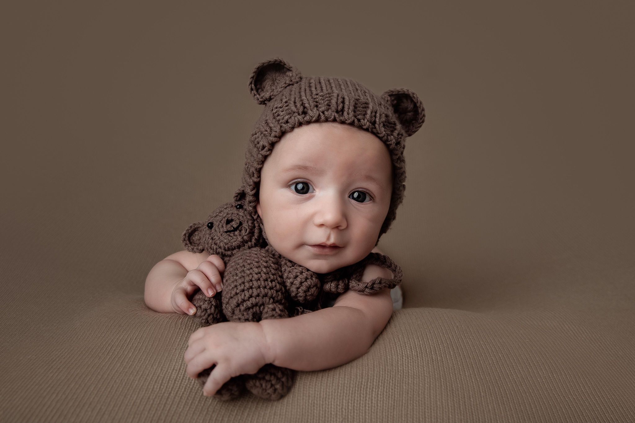  studio portrait of baby boy with teddy bear