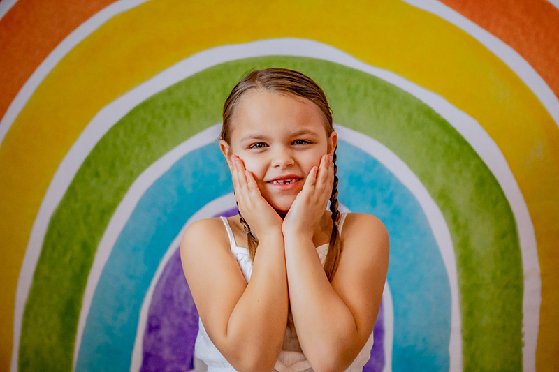 little girl with coloured backdrop