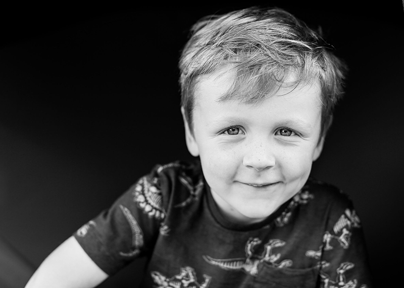 studio portrait of boy in black and white