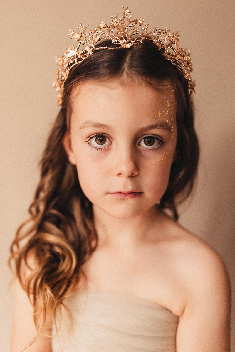 studio portrait of little girl with tiara on her head