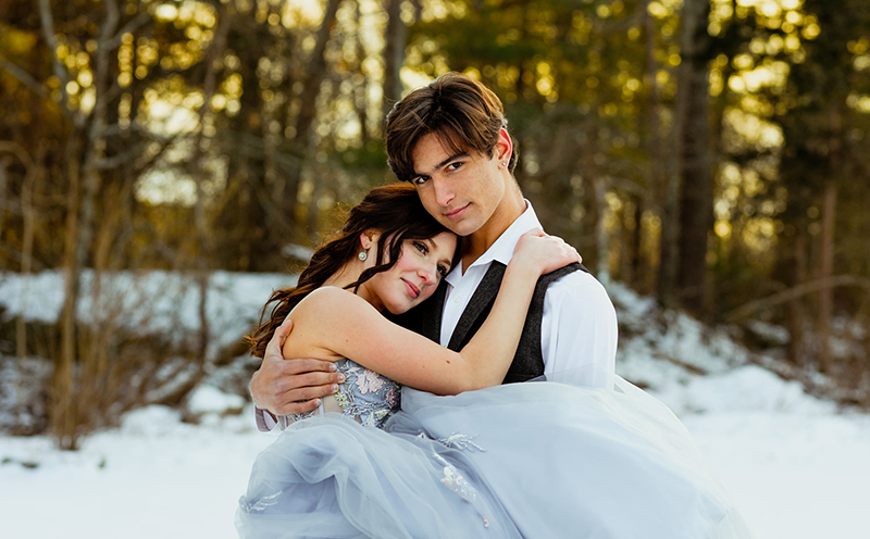 teen girl and guy in formal wear in the snow