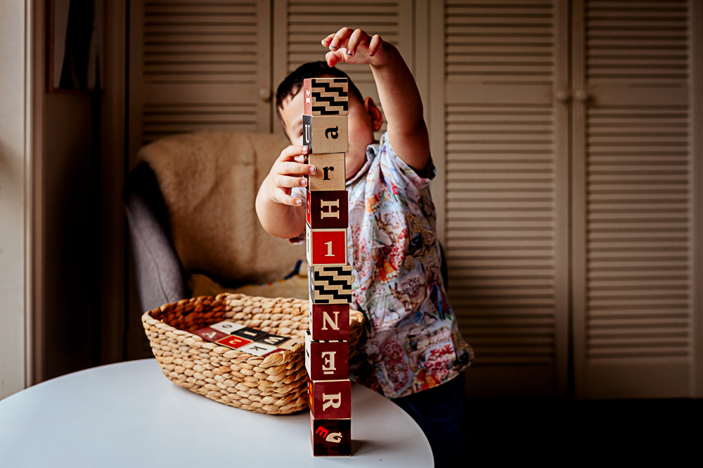 toddler boy stacking blocks