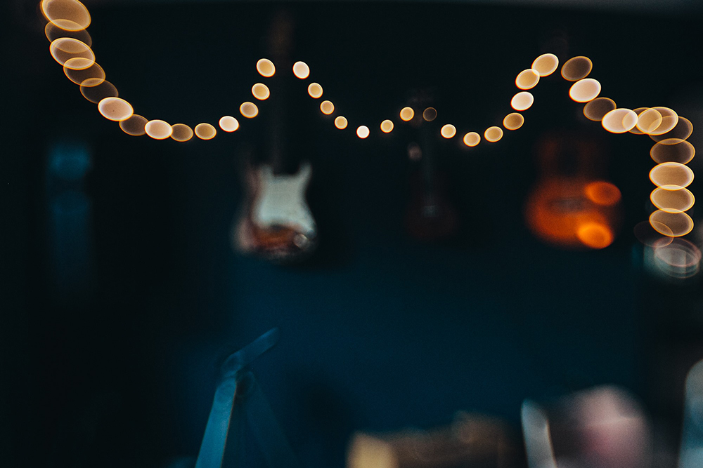 selective focus image of guitars and fairy lights