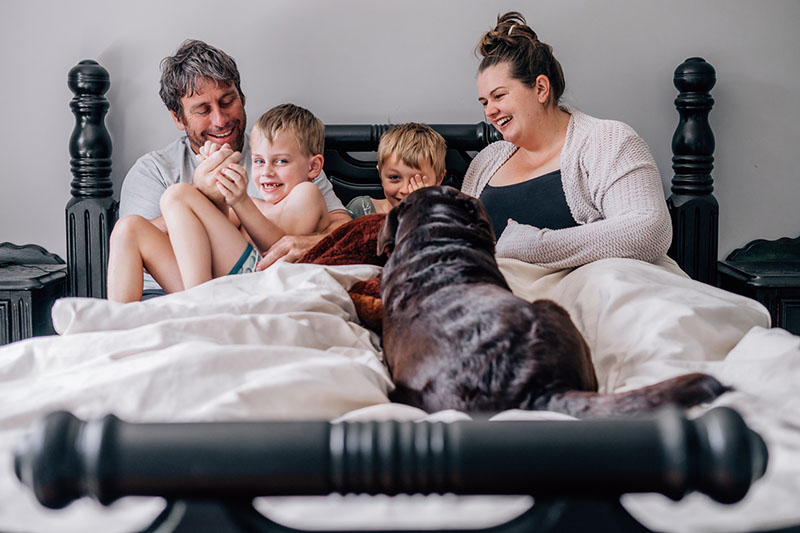 parents children and dog in bed