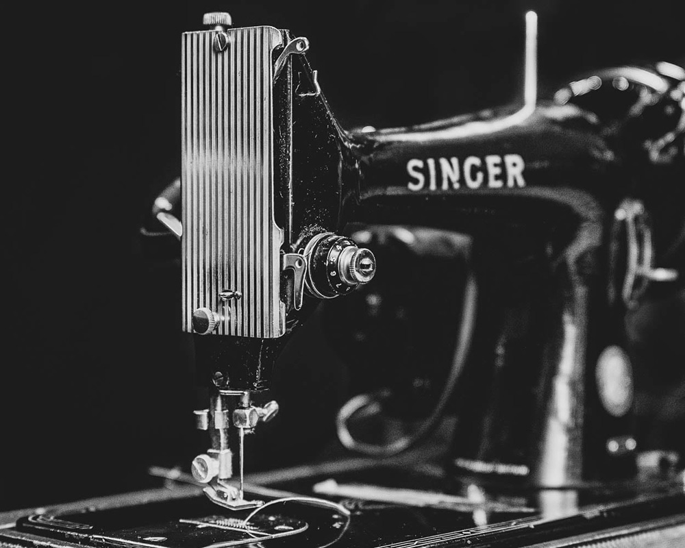 black and white photograph of vintage singer sewing machine