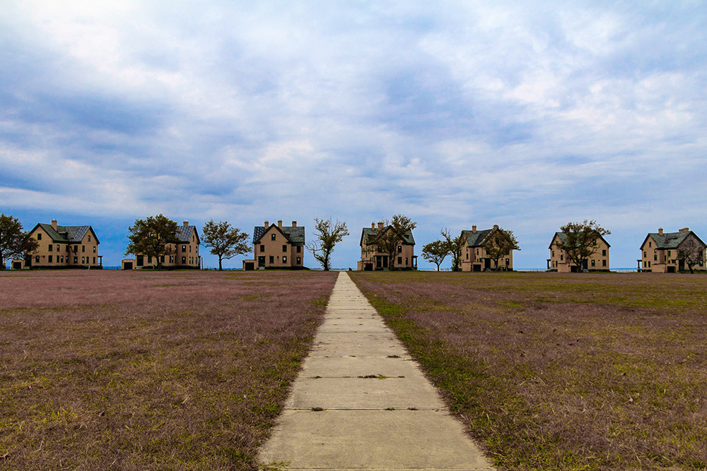 landscape with triangular houses and leading line path