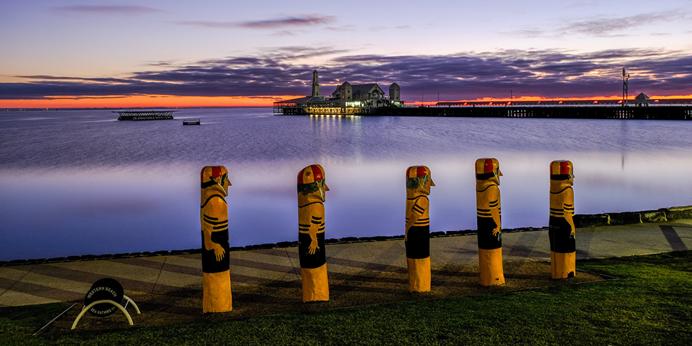 landscape of pier and beach with purple sky