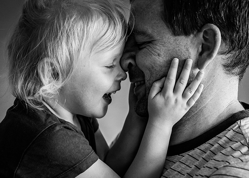father and toddler daughter embracing