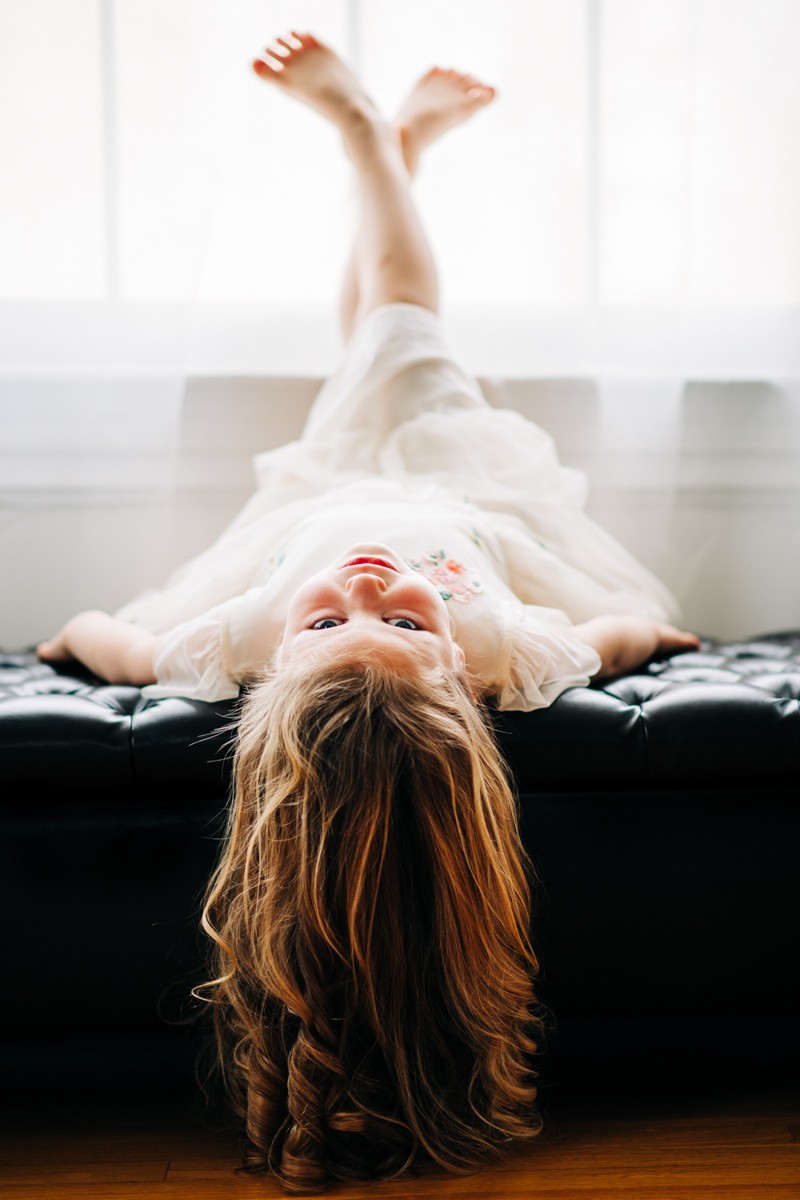 natural light portrait of young girl lying down