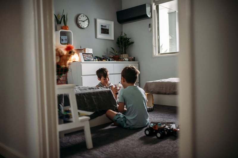 two young brothers talking in bedroom