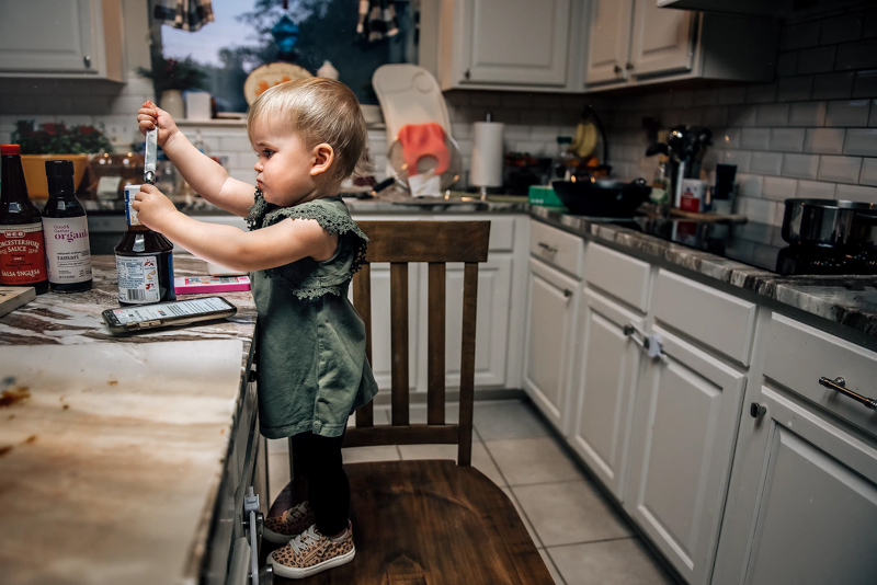 toddler girl helping in the kitchen