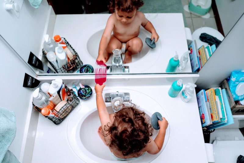 Top down portrait of toddler sitting in sink