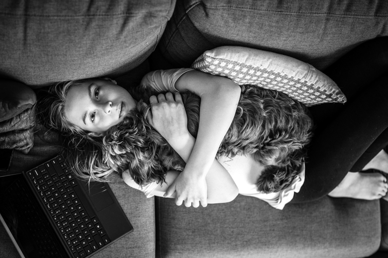 top down black and white portrait of young girl with dog