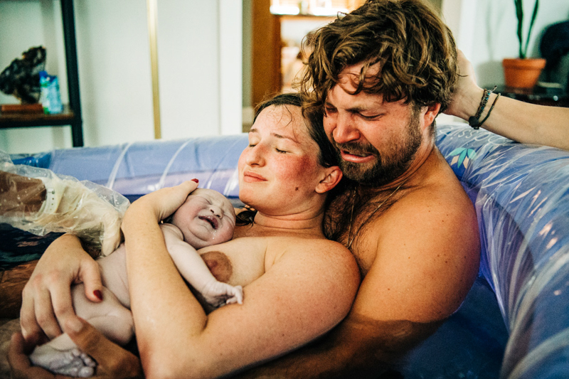 couple in birthing pool with new baby