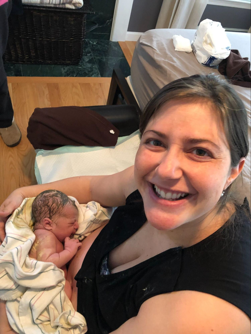 smiling mother holding newborn baby