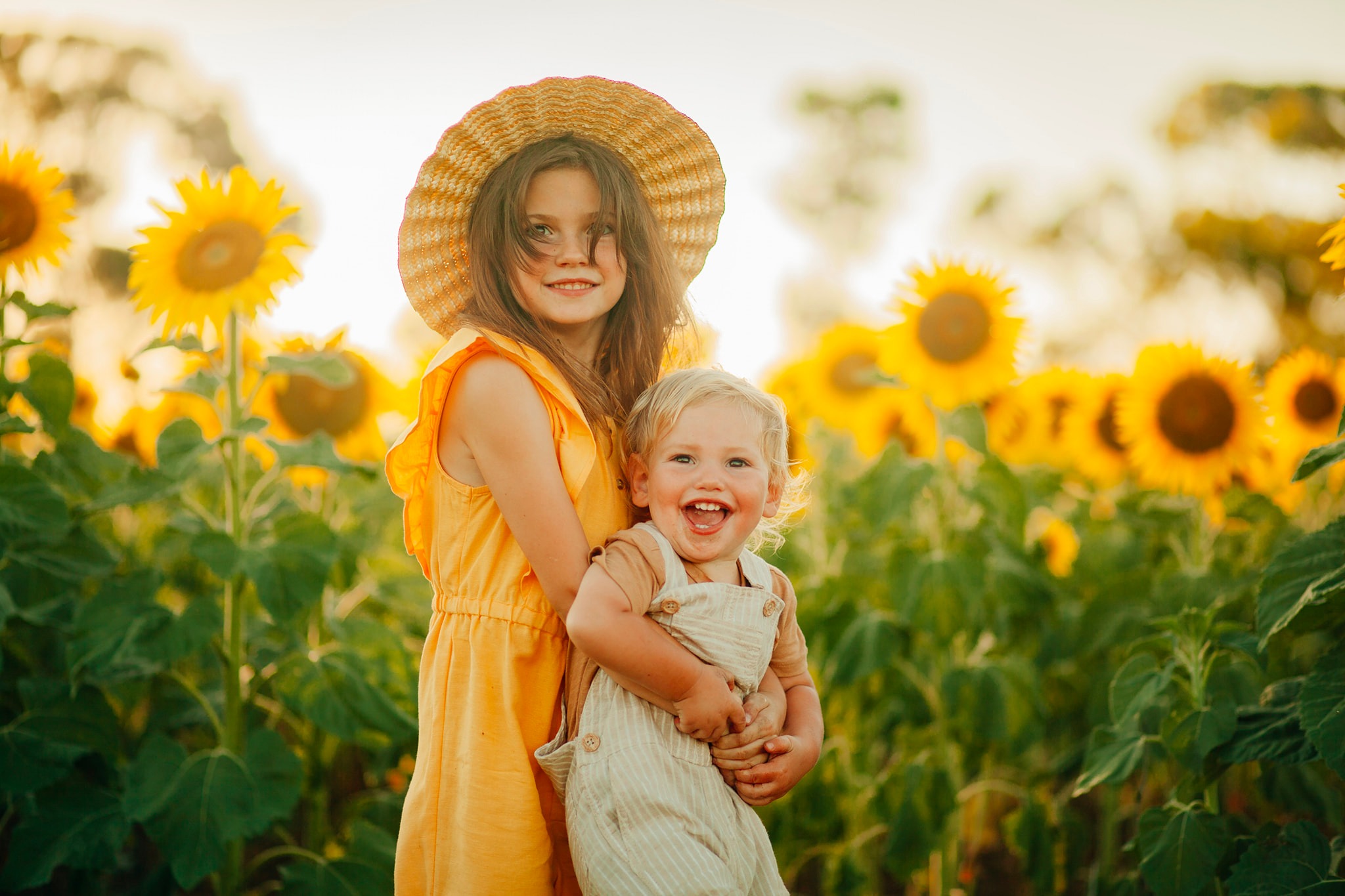 two kids in sunflower field