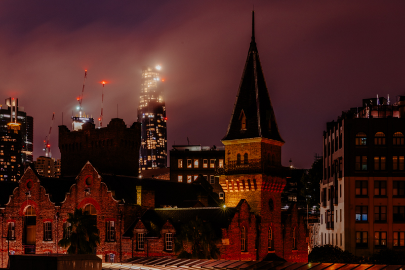 church spire and city scape at night