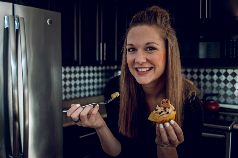 portrait of young woman with cupcake