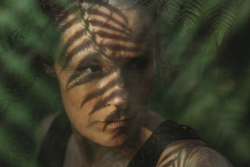 self portrait of woman with fern double exposure