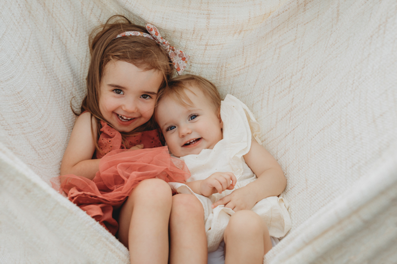 family photoshoot ideas of two little girls in a hammock