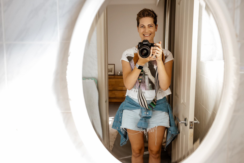 bright and airy photo of woman reflected in mirror