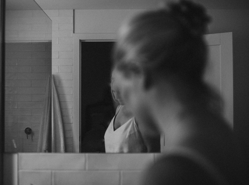black and white portrait of woman reflected in a mirror
