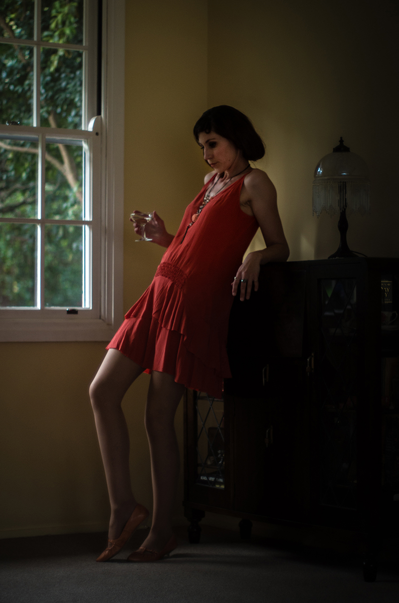 image of woman holding glass inspired by the 1920s