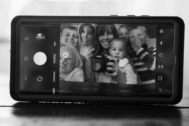 portrait of family displayed on phone screen