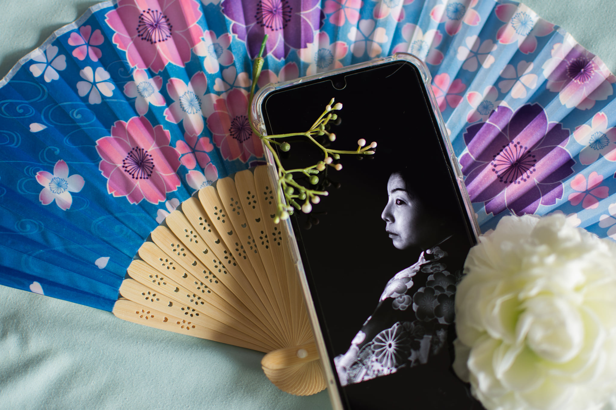 portrait of woman in traditional Japanese kimono displayed on phone screen