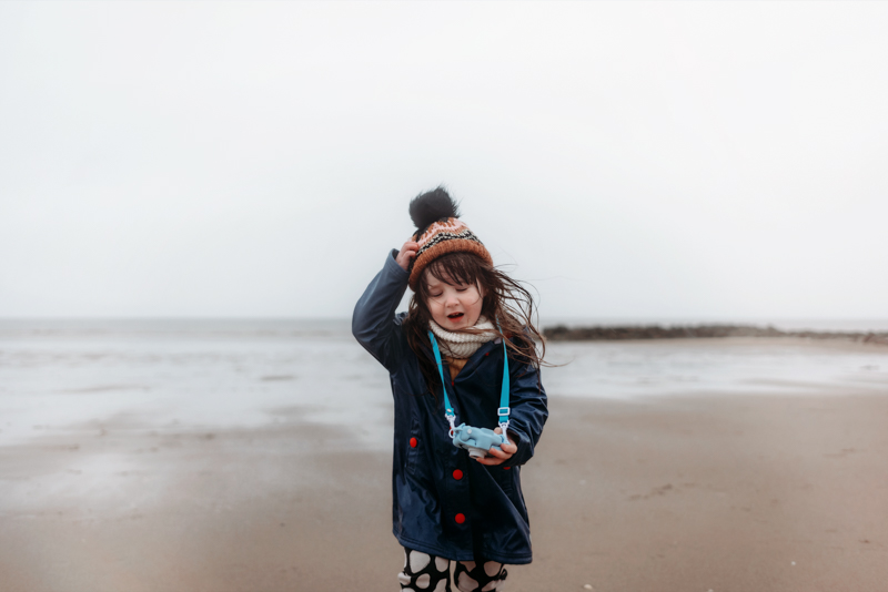portrait of young girl on windswept beach