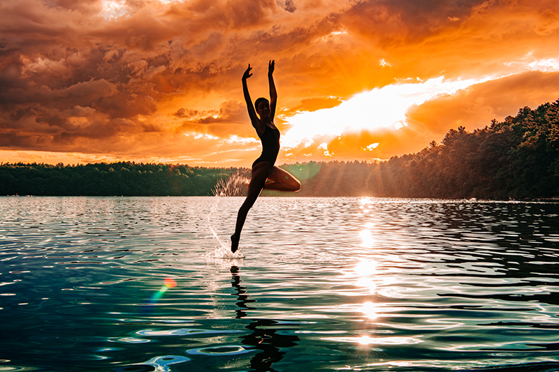 jumping dancer in sunset backlight photo