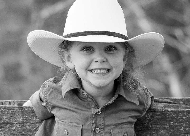 black and white portrait of young girl in cowboy hat